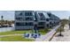 Beautiful condo building with balconies, manicured lawn and outdoor seating at 2400 N Beach Rd # 1, Englewood, FL 34223