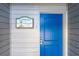Bright blue front door with welcome sign to a charming beach house at 2400 N Beach Rd # 1, Englewood, FL 34223