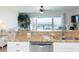 Open kitchen with granite counter opens to a living area and large sliding glass door to the beach at 2400 N Beach Rd # 1, Englewood, FL 34223