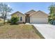 Charming single Gathering home with a 2-car garage, landscaped front yard and neutral colored exterior at 2499 Trimble Ave, North Port, FL 34288