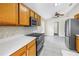 Eat-in kitchen with wooden cabinetry, stainless steel appliances and tile flooring at 2499 Trimble Ave, North Port, FL 34288