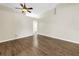 Open living room with wood-look flooring, a ceiling fan, and an open layout at 2499 Trimble Ave, North Port, FL 34288