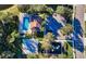 Aerial view of community pool, basketball court, playground, parking area, and surrounding trees at 2808 124Th E Ave, Parrish, FL 34219