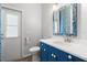 Charming powder room with blue vanity, shell accents and decorative mirror at 2808 124Th E Ave, Parrish, FL 34219