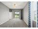 Bright bedroom with carpet, curtains, and a sliding glass door that provides views of the outdoors at 2808 124Th E Ave, Parrish, FL 34219