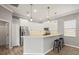 Contemporary kitchen featuring white cabinets, pendant lighting, and a convenient breakfast bar at 2808 124Th E Ave, Parrish, FL 34219