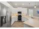 Modern kitchen featuring stainless steel appliances, white cabinetry, and stylish backsplash at 2808 124Th E Ave, Parrish, FL 34219