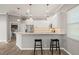 Updated kitchen with bar seating, white cabinets, and stainless steel appliances at 2808 124Th E Ave, Parrish, FL 34219