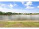 Peaceful lake view with lush green surroundings and clear skies at 2808 124Th E Ave, Parrish, FL 34219