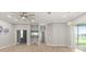 Bright living room with neutral colors, wood floors, large windows, and a contemporary ceiling fan at 2808 124Th E Ave, Parrish, FL 34219