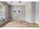 A cozy living room with natural light, wood laminate floors, and charming decor at 2808 124Th E Ave, Parrish, FL 34219