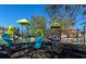 Community playground featuring slides, climbing structures, and protective black rubber mulch at 2808 124Th E Ave, Parrish, FL 34219