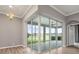 Bright sunroom with expansive windows offering panoramic views of the outdoor space at 2808 124Th E Ave, Parrish, FL 34219