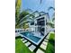 Stunning backyard showcasing a modern pool, spiral staircase, and lush tropical landscaping at 2809 Avenue E, Holmes Beach, FL 34217