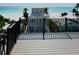 Enjoy beach views from the deck of a beautiful home with detailed railings in a coastal setting at 2809 Avenue E, Holmes Beach, FL 34217