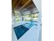 An outdoor living space featuring a modern pool with integrated spa and dark wood ceilings at 2809 Avenue E, Holmes Beach, FL 34217