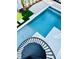 A luxurious pool with a spa is steps away from a spiral staircase and artificial turf at 2809 Avenue E, Holmes Beach, FL 34217