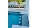 A pool with in-water bar stools and accent tiling offers a relaxing outdoor experience at 2809 Avenue E, Holmes Beach, FL 34217