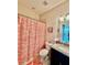 Bathroom includes a vanity with a sink, toilet, and a shower with patterned curtain at 3120 Oriole Dr # 101, Sarasota, FL 34243