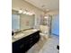Granite counters highlight this bathroom featuring double sinks and a separate shower at 3120 Oriole Dr # 101, Sarasota, FL 34243
