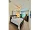 Cozy bedroom with a ceiling fan, window, a wooden bed frame, and neutral decor at 3120 Oriole Dr # 101, Sarasota, FL 34243
