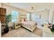 Bright bedroom featuring a ceiling fan and two windows, with neutral walls and carpet at 3120 Oriole Dr # 101, Sarasota, FL 34243