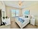 Bright bedroom features a ceiling fan and a window overlooking the neighborhood at 3120 Oriole Dr # 101, Sarasota, FL 34243