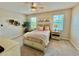 Bedroom featuring neutral colors, carpet, a ceiling fan, and two windows at 3120 Oriole Dr # 101, Sarasota, FL 34243