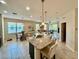 Open-concept kitchen and dining area with an island featuring granite countertops and views into the living room at 3120 Oriole Dr # 101, Sarasota, FL 34243