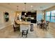 Kitchen with dark cabinets, granite countertops, stainless steel appliances, and an eat-in area with a glass table at 3120 Oriole Dr # 101, Sarasota, FL 34243