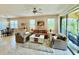 Bright living room with neutral colors, a ceiling fan, tile floors, and sliding glass doors that lead to a balcony at 3120 Oriole Dr # 101, Sarasota, FL 34243