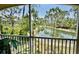 Screened in patio overlooking pond surrounded by beautiful trees and foliage at 3120 Oriole Dr # 101, Sarasota, FL 34243