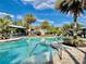Beautiful community pool surrounded by tropical landscaping and lounge chairs, perfect for relaxation at 3120 Oriole Dr # 101, Sarasota, FL 34243