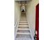 Carpeted staircase leads to the upper level, blending functionality with aesthetic appeal at 3120 Oriole Dr # 101, Sarasota, FL 34243