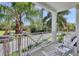 Relaxing balcony area with seating and a view of lush tropical foliage at 3430 77Th W St # 103, Bradenton, FL 34209