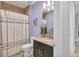 Well-lit bathroom with a shower and a vanity with a granite countertop at 3430 77Th W St # 103, Bradenton, FL 34209
