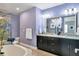 Elegant bathroom with a double vanity, soaking tub, and modern fixtures at 3430 77Th W St # 103, Bradenton, FL 34209