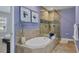 Bathroom featuring a soaking tub with tile surround and glass enclosed shower at 3430 77Th W St # 103, Bradenton, FL 34209