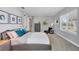 Comfortable bedroom with a soft bed, lots of natural light, and art pieces adorning the walls at 3430 77Th W St # 103, Bradenton, FL 34209