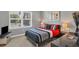 Nicely appointed bedroom with a large window, gray walls, and red accent bedding at 3430 77Th W St # 103, Bradenton, FL 34209