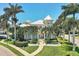 Stunning home featuring lush landscaping, tropical palm trees, and a charming front porch at 3430 77Th W St # 103, Bradenton, FL 34209