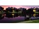 Scenic twilight view of the condo buildings with palm trees reflecting in the tranquil lake at 3430 77Th W St # 103, Bradenton, FL 34209
