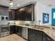 Well-lit kitchen featuring dark cabinets, stainless steel appliances, and granite countertops at 3430 77Th W St # 103, Bradenton, FL 34209