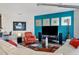 Living room with sleek furniture, stylish decor, and a bold teal accent wall at 3430 77Th W St # 103, Bradenton, FL 34209