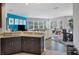 Open-concept living room connected to kitchen, boasting large windows and contemporary decor at 3430 77Th W St # 103, Bradenton, FL 34209