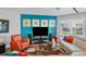 This living room offers stylish furniture, a vibrant accent wall, and a bright, airy atmosphere at 3430 77Th W St # 103, Bradenton, FL 34209