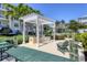 Outdoor picnic and grill area with lush tropical landscaping at 3430 77Th W St # 103, Bradenton, FL 34209