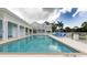 Community pool featuring lounge chairs and covered seating areas, surrounded by well-maintained grounds at 3430 77Th W St # 103, Bradenton, FL 34209