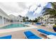 Stunning pool area with lounge chairs, outdoor seating, and lush tropical landscaping at 3430 77Th W St # 103, Bradenton, FL 34209