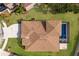 Aerial view showcases a beautiful home with a private screened-in pool, landscaped yard, and extended driveway at 4119 101St E Ave, Parrish, FL 34219